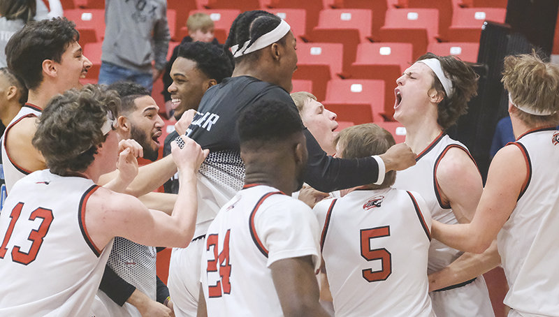 The Trappers swarm Kolter Merritt after he tipped in the game winning shot against Lamar Community College on March 9.
TRIBUNE PHOTO BY SETH ROMSA