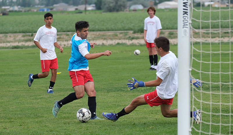 Martin Weisner slides a shot past Inigo Chavarria Bezunartea during practice last week as a new-looking Trapper men’s soccer team prepped for its first action this week. The team begins play Wednesday in Billings.
TRIBUNE PHOTO BY SETH ROMSA