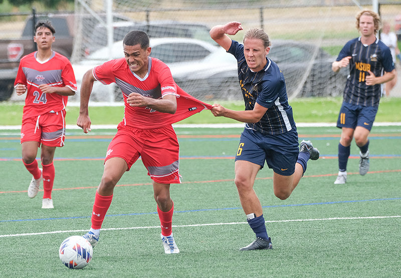 NWC freshman Ricardo Farias da Silva (center) tries to get away from a Montana State University Billings defender during the Trappers exhibition game on Saturday.
TRIBUNE PHOTO BY SETH ROMSA