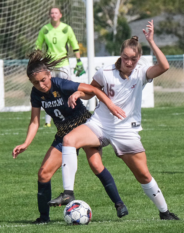 Katelynn Campbell battles in the midfield with a Trinidad player on Friday. The Trappers head out on the road for Region IX play this weekend.
TRIBUNE PHOTO BY SETH ROMSA